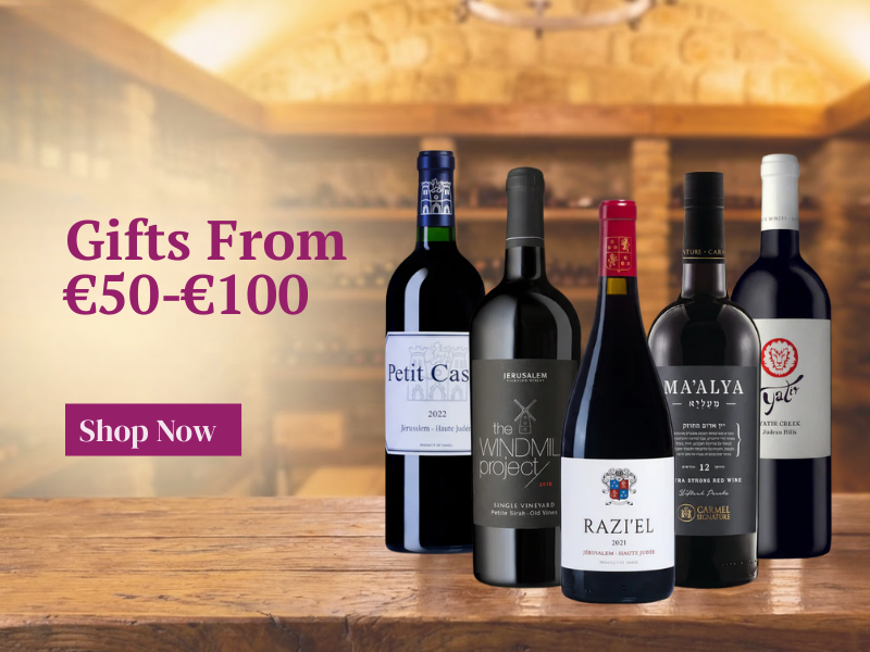 Five wine bottles on a wooden surface with promotional text for gifts in the €50-€100 range.