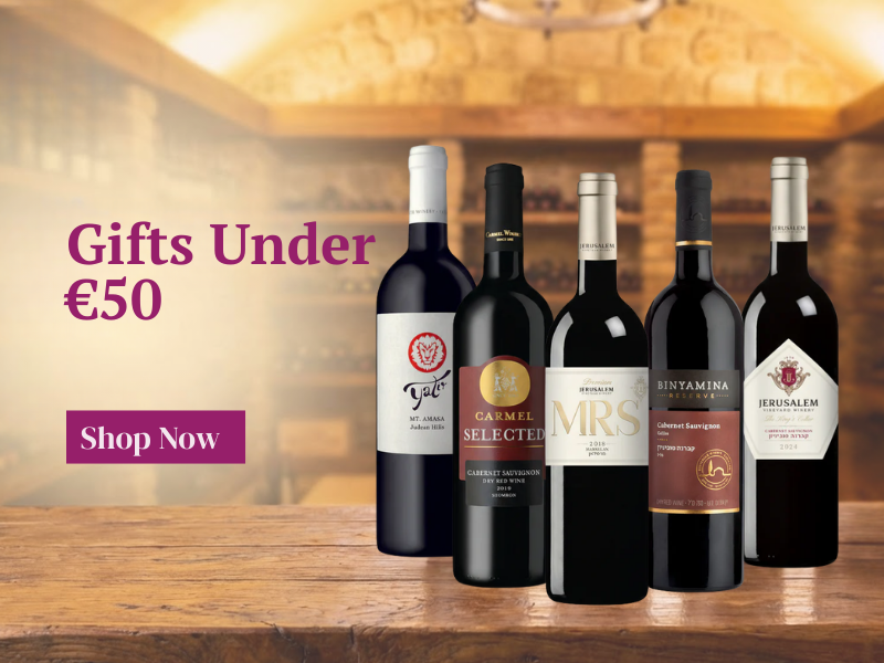Five wine bottles on a wooden table with a blurred background, featuring promotional text for gifts under €50.