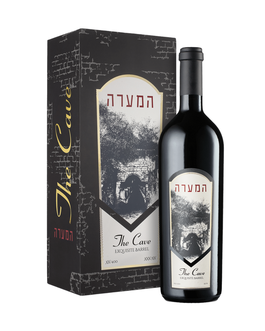 A bottle of wine and its matching gift box, both featuring a black and white illustration of a cave with Hebrew text at the top and the brand name 'The Cave' in gold script.