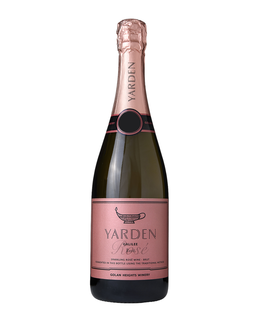 A bottle of Yarden Galilee Rose sparkling wine with a dark green glass body, a dusty pink label, and a metallic pink foil top, isolated on a white background.